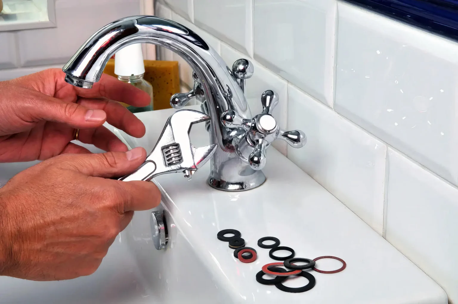 Plumber repairing a bathroom faucet in West Valley City