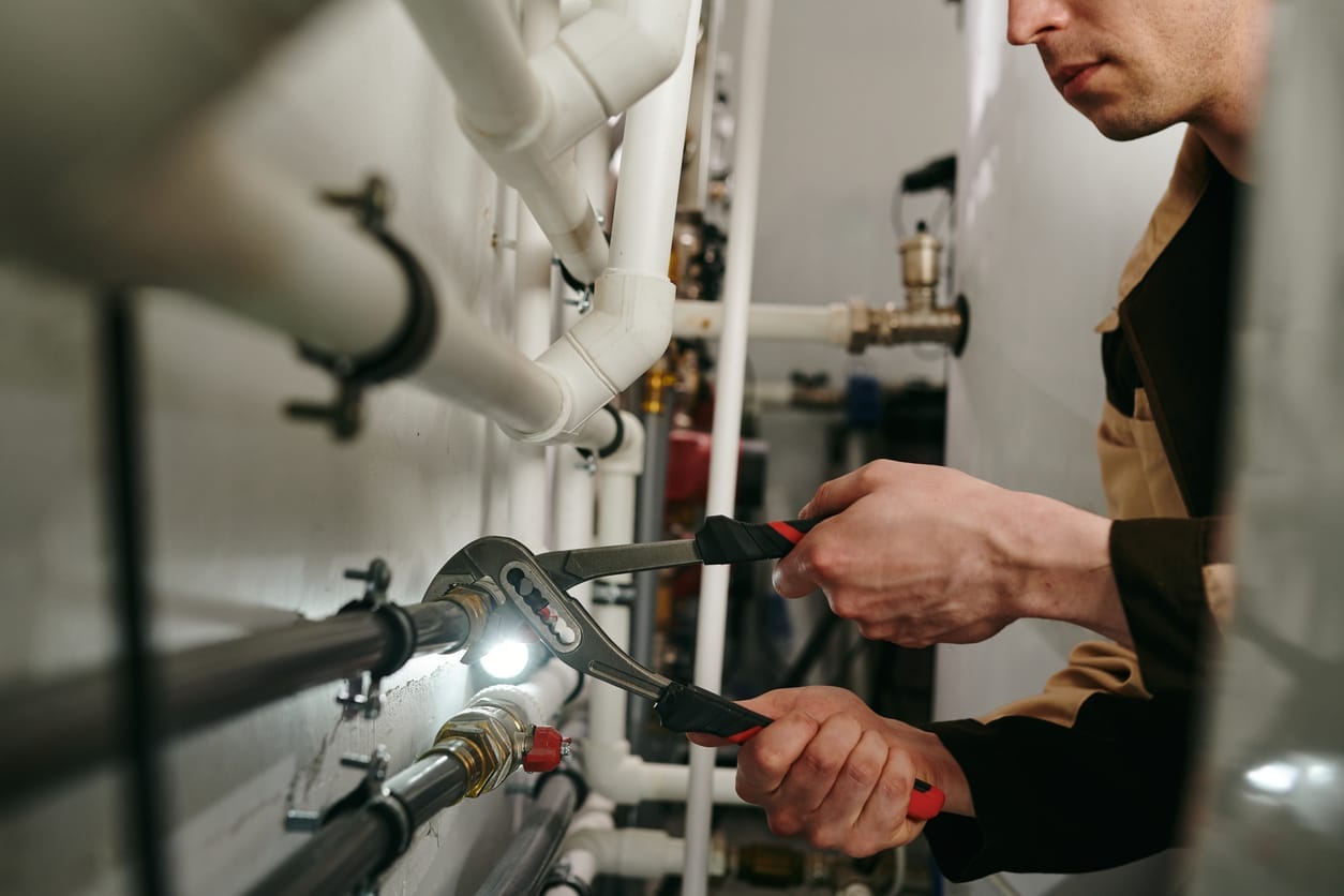 Plumbers maintaining commercial plumbing pipes in West Valley City