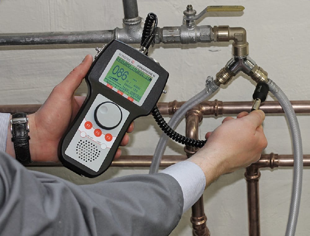Plumber testing pipes with electronic leak detection equipment in West Valley City