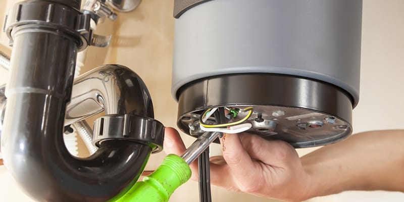 Technician repairing the heating element of a water heater in West Valley City
