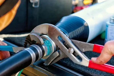 Technician tightening an industrial pipe connection in West Valley City
